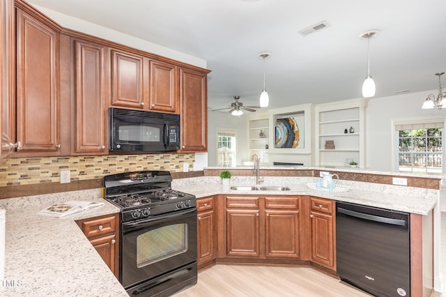 1148 Dexter Ridge Dr, Holly Springs, NC 27540 - kitchen featuring black appliances, light stone countertops, a peninsula, and decorative backsplash