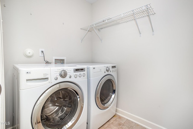 1148 Dexter Ridge Dr, Holly Springs, NC 27540 - washroom featuring separate washer and dryer and light tile patterned floors