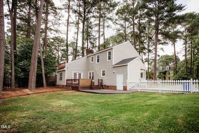 1702 Chamberlain Dr NW, Wilson, NC 27896 - rear view of property featuring a deck, a chimney, and crawl space