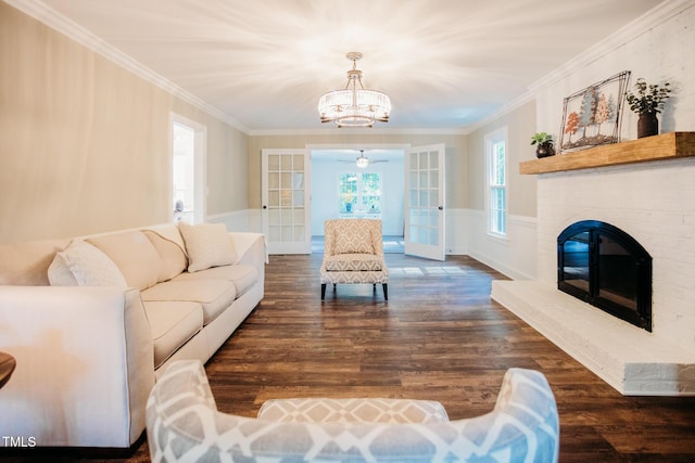1702 Chamberlain Dr NW, Wilson, NC 27896 - living area with a chandelier, dark wood-type flooring, french doors, ornamental molding, and a wainscoted wall