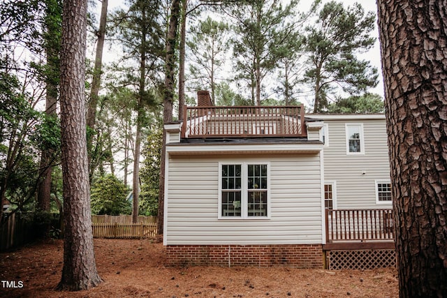 1702 Chamberlain Dr NW, Wilson, NC 27896 - rear view of property featuring a balcony, a chimney, and a deck