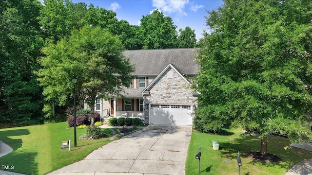 728 Opposition Way, Wake Forest, NC 27587 - view of front of house featuring a porch, driveway, a front lawn, and stone siding