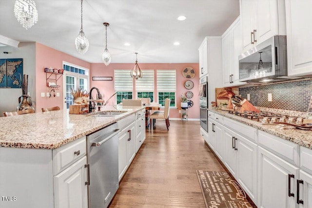 728 Opposition Way, Wake Forest, NC 27587 - kitchen featuring stainless steel appliances, decorative backsplash, light wood finished floors, white cabinets, and recessed lighting