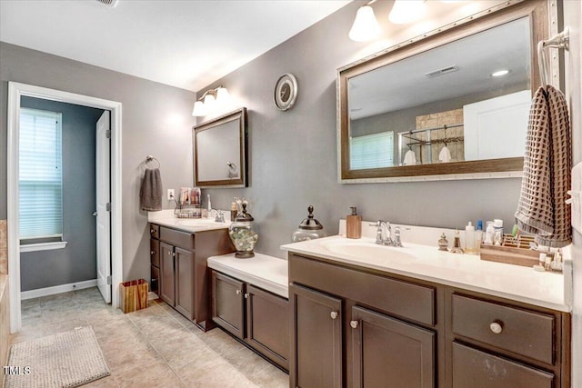 728 Opposition Way, Wake Forest, NC 27587 - full bathroom with two vanities, tile patterned flooring, and a tile shower