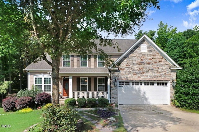 728 Opposition Way, Wake Forest, NC 27587 - view of front of home featuring covered porch, driveway, stone siding, and an attached garage
