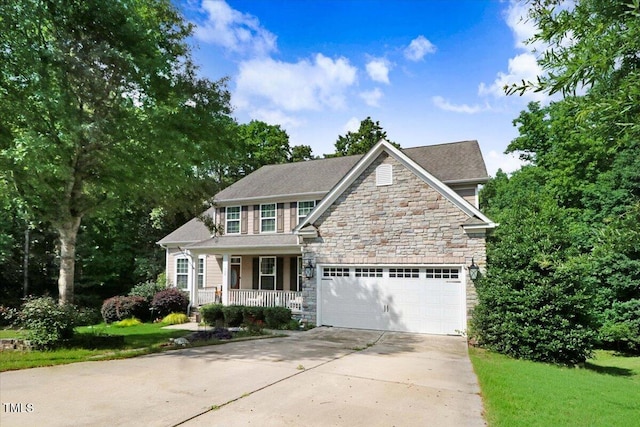 728 Opposition Way, Wake Forest, NC 27587 - view of front of property with a porch, concrete driveway, stone siding, a garage, and a front yard