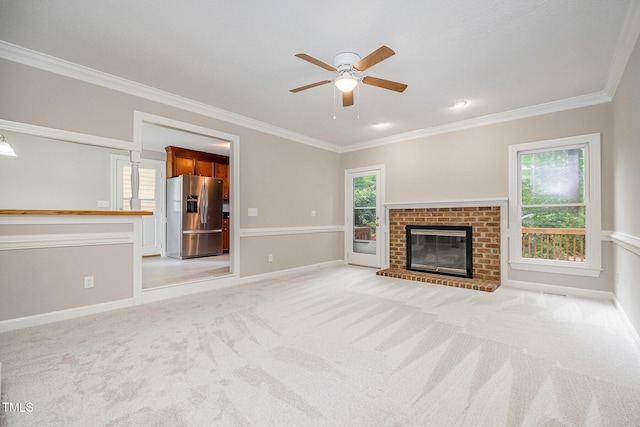 2629 Hiking Trl, Raleigh, NC 27615 - unfurnished living room featuring ornamental molding, a ceiling fan, light colored carpet, and a brick fireplace