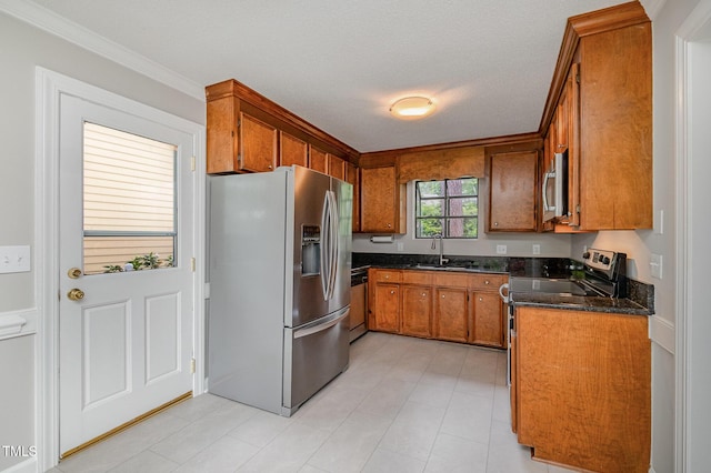 2629 Hiking Trl, Raleigh, NC 27615 - kitchen with stainless steel appliances, brown cabinets, crown molding, and dark stone counters