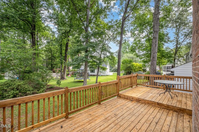 2629 Hiking Trl, Raleigh, NC 27615 - deck featuring a trampoline and a lawn