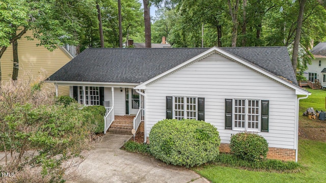 2629 Hiking Trl, Raleigh, NC 27615 - view of front of property featuring roof with shingles, a porch, and a chimney