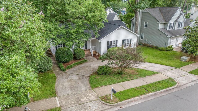 2629 Hiking Trl, Raleigh, NC 27615 - view of front of house with covered porch, a front lawn, driveway, and roof with shingles
