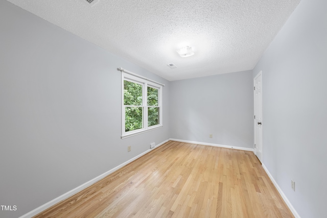 3517 Eden Croft Dr, Raleigh, NC 27612 - spare room with light wood finished floors and a textured ceiling