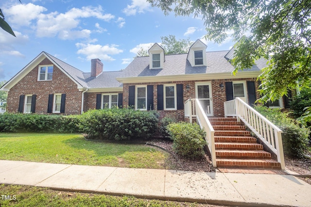 3913 Littlefield Ct, Raleigh, NC 27606 - cape cod house with brick siding, a front yard, and roof with shingles