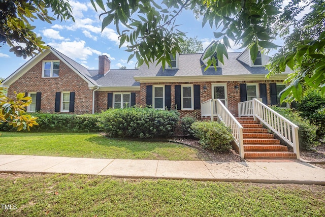 3913 Littlefield Ct, Raleigh, NC 27606 - view of front of property with brick siding, a front lawn, a shingled roof, and a chimney