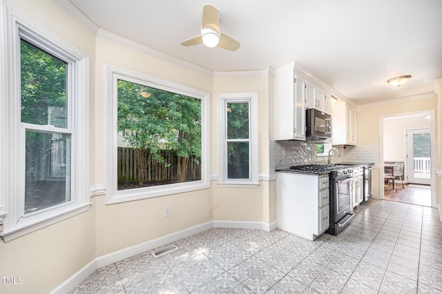 3913 Littlefield Ct, Raleigh, NC 27606 - kitchen featuring stainless steel appliances, decorative backsplash, white cabinets, ceiling fan, and crown molding