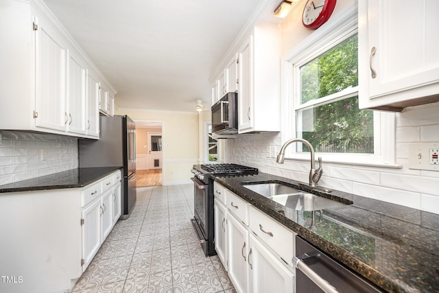 3913 Littlefield Ct, Raleigh, NC 27606 - kitchen with stainless steel appliances, white cabinets, tasteful backsplash, and dark stone countertops