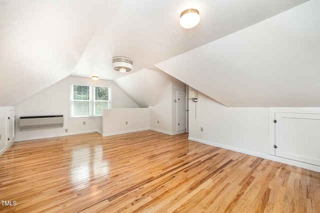 3913 Littlefield Ct, Raleigh, NC 27606 - bonus room featuring a wall unit AC, light wood-style floors, and vaulted ceiling