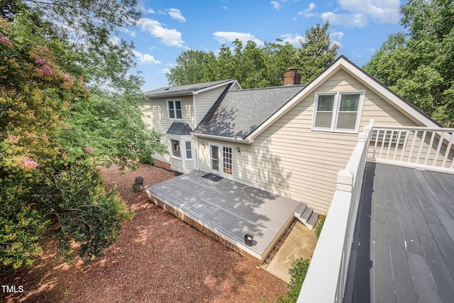 3913 Littlefield Ct, Raleigh, NC 27606 - back of house with a deck, a chimney, and roof with shingles