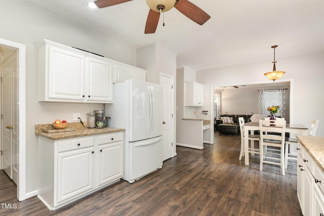 1001 Kingsway Dr, Apex, NC 27502 - kitchen featuring freestanding refrigerator, ceiling fan, dark wood finished floors, white cabinets, and hanging light fixtures