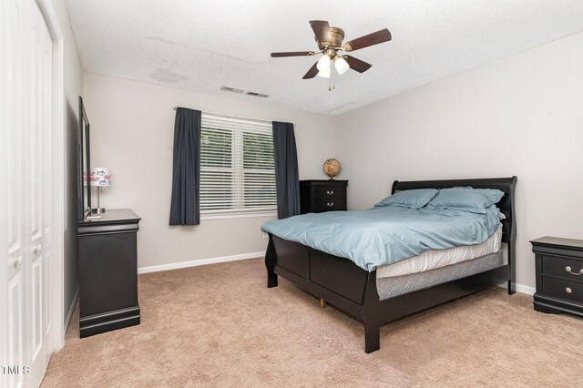 1001 Kingsway Dr, Apex, NC 27502 - bedroom with light carpet, a ceiling fan, and a textured ceiling