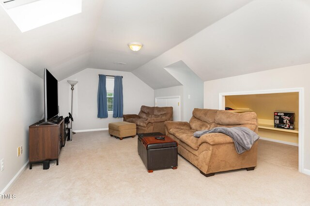 1001 Kingsway Dr, Apex, NC 27502 - living area featuring light colored carpet, lofted ceiling, and a skylight