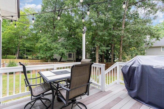 1001 Kingsway Dr, Apex, NC 27502 - wooden deck with outdoor dining area, a grill, and view of wooded area