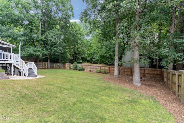 1001 Kingsway Dr, Apex, NC 27502 - fenced backyard featuring stairway, a deck, and view of wooded area