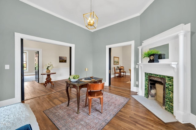 210 E Trinity Ave, Durham, NC 27701 - dining space featuring wood finished floors, crown molding, a chandelier, and a fireplace with flush hearth
