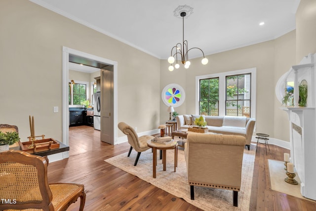 210 E Trinity Ave, Durham, NC 27701 - living room with ornamental molding, hardwood / wood-style floors, a chandelier, and a fireplace with flush hearth