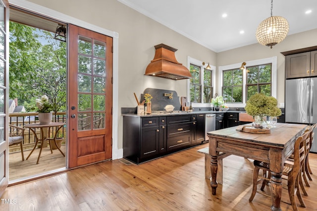 210 E Trinity Ave, Durham, NC 27701 - kitchen featuring custom range hood, freestanding refrigerator, light wood finished floors, crown molding, and dark cabinets