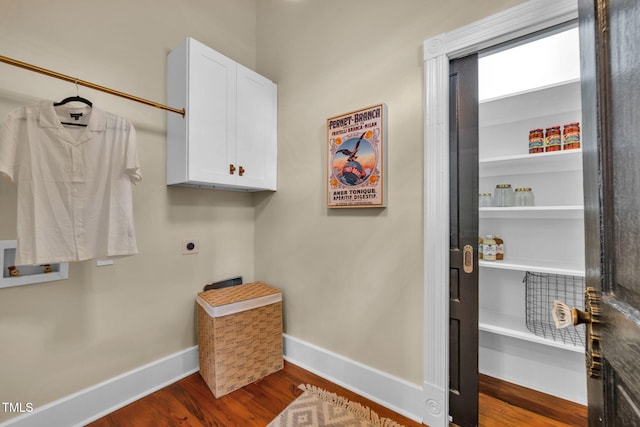 210 E Trinity Ave, Durham, NC 27701 - laundry room featuring cabinet space, electric dryer hookup, and dark wood finished floors