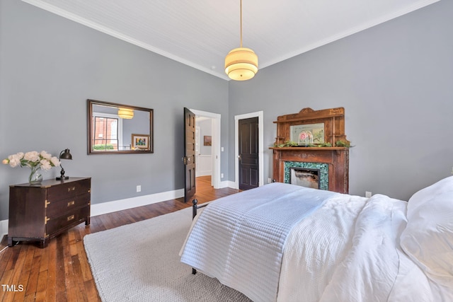 210 E Trinity Ave, Durham, NC 27701 - bedroom with ornamental molding, wood finished floors, and a fireplace
