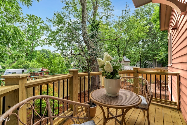 210 E Trinity Ave, Durham, NC 27701 - wooden terrace featuring view of wooded area