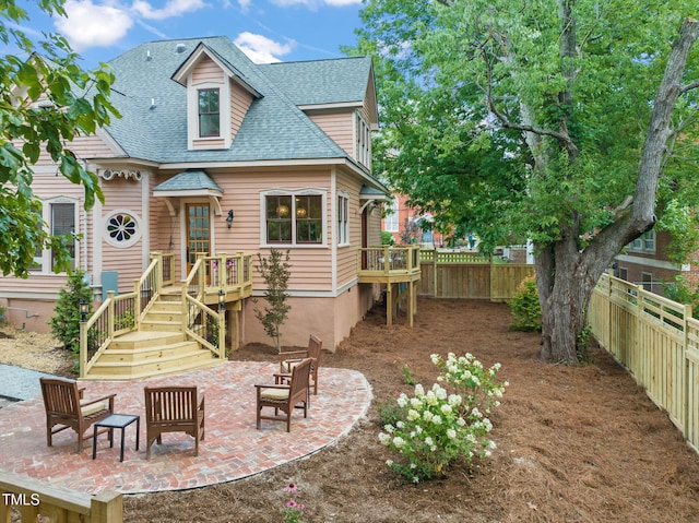 210 E Trinity Ave, Durham, NC 27701 - back of house featuring a shingled roof, a fenced backyard, a patio area, and a wooden deck
