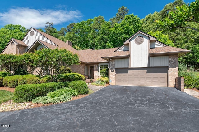 104 Cedar Ridge Way, Durham, NC 27705 - view of front of home featuring brick siding, asphalt driveway, roof with shingles, and an attached garage