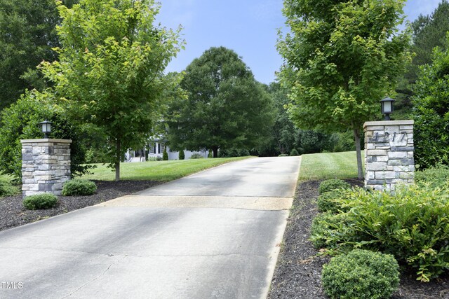 4217 Grahamstone Rd, Raleigh, NC 27610 - view of concrete driveway featuring street lighting