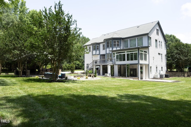 4217 Grahamstone Rd, Raleigh, NC 27610 - back of property featuring a patio area, a sunroom, and a lawn