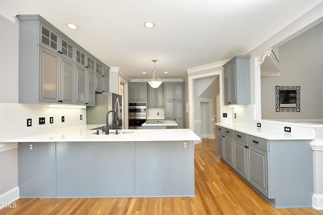 4217 Grahamstone Rd, Raleigh, NC 27610 - kitchen with gray cabinetry, a peninsula, appliances with stainless steel finishes, recessed lighting, and ornamental molding
