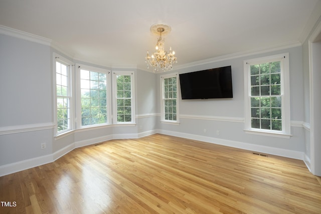4217 Grahamstone Rd, Raleigh, NC 27610 - unfurnished room with a chandelier, light wood-type flooring, healthy amount of natural light, and ornamental molding