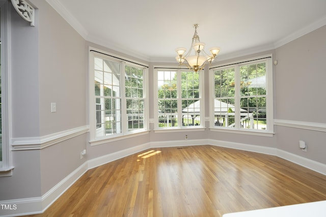 4217 Grahamstone Rd, Raleigh, NC 27610 - unfurnished dining area with a chandelier, wood finished floors, and crown molding