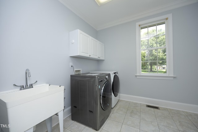 4217 Grahamstone Rd, Raleigh, NC 27610 - washroom with cabinet space, washing machine and clothes dryer, ornamental molding, and light tile patterned floors