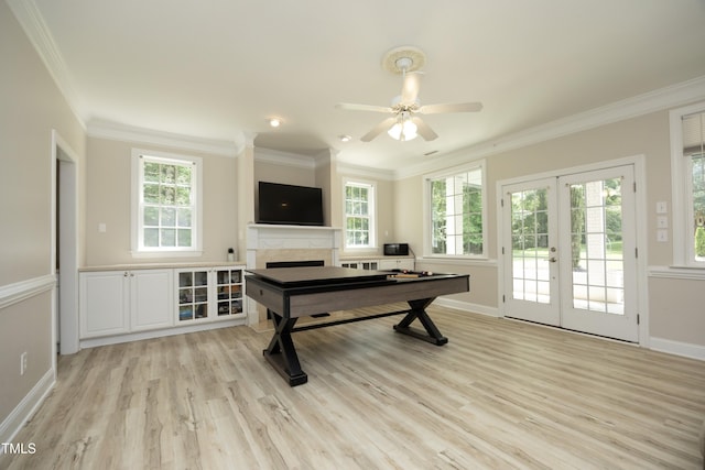 4217 Grahamstone Rd, Raleigh, NC 27610 - recreation room featuring crown molding, light wood finished floors, a high end fireplace, french doors, and plenty of natural light