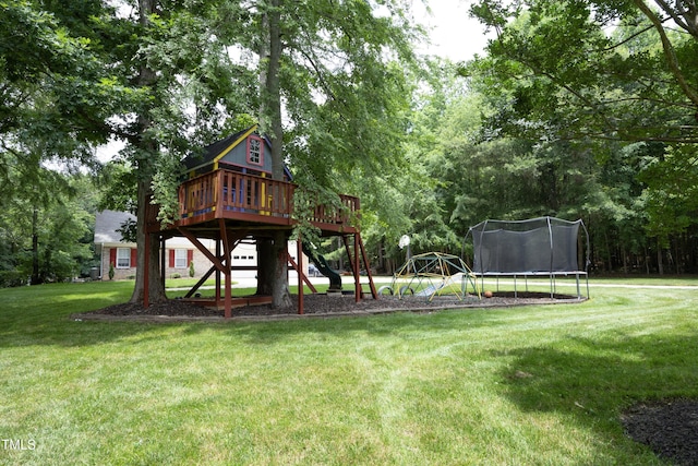 4217 Grahamstone Rd, Raleigh, NC 27610 - view of playground featuring a trampoline, a lawn, a deck, and view of wooded area