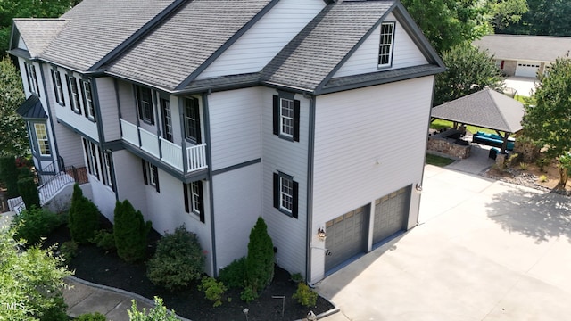 4217 Grahamstone Rd, Raleigh, NC 27610 - view of side of home featuring a garage, concrete driveway, and roof with shingles