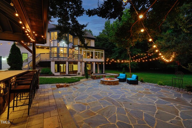 4217 Grahamstone Rd, Raleigh, NC 27610 - view of patio / terrace with a fire pit, stairs, a wooden deck, and a sunroom