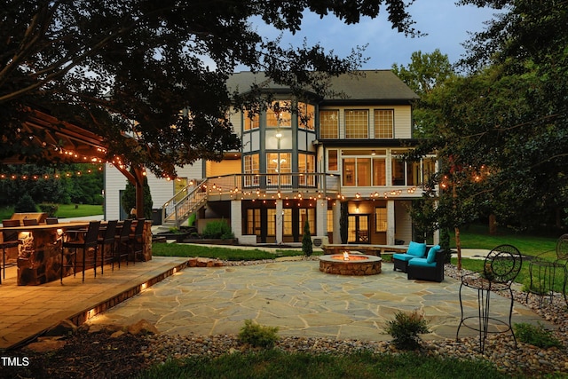 4217 Grahamstone Rd, Raleigh, NC 27610 - rear view of property with a patio area, stairway, an outdoor living space with a fire pit, and a deck