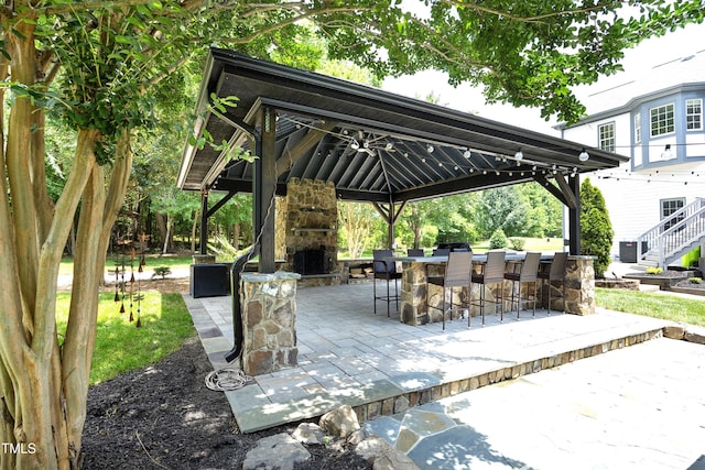 4217 Grahamstone Rd, Raleigh, NC 27610 - view of patio with a gazebo and an outdoor stone fireplace