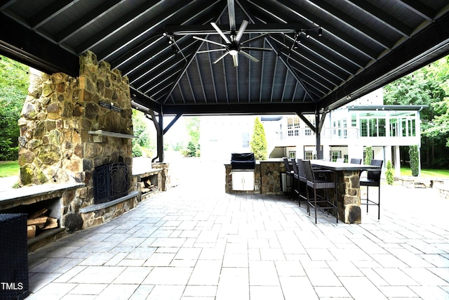 4217 Grahamstone Rd, Raleigh, NC 27610 - view of patio featuring a gazebo, an outdoor stone fireplace, exterior bar, and exterior kitchen