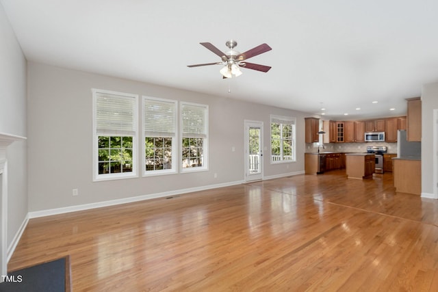 1304 Trailing Rose Ct, Wake Forest, NC 27587 - unfurnished living room with ceiling fan, light wood-type flooring, and recessed lighting