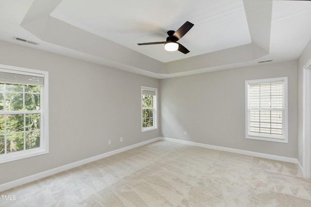 1304 Trailing Rose Ct, Wake Forest, NC 27587 - unfurnished room with a tray ceiling, light carpet, and a ceiling fan